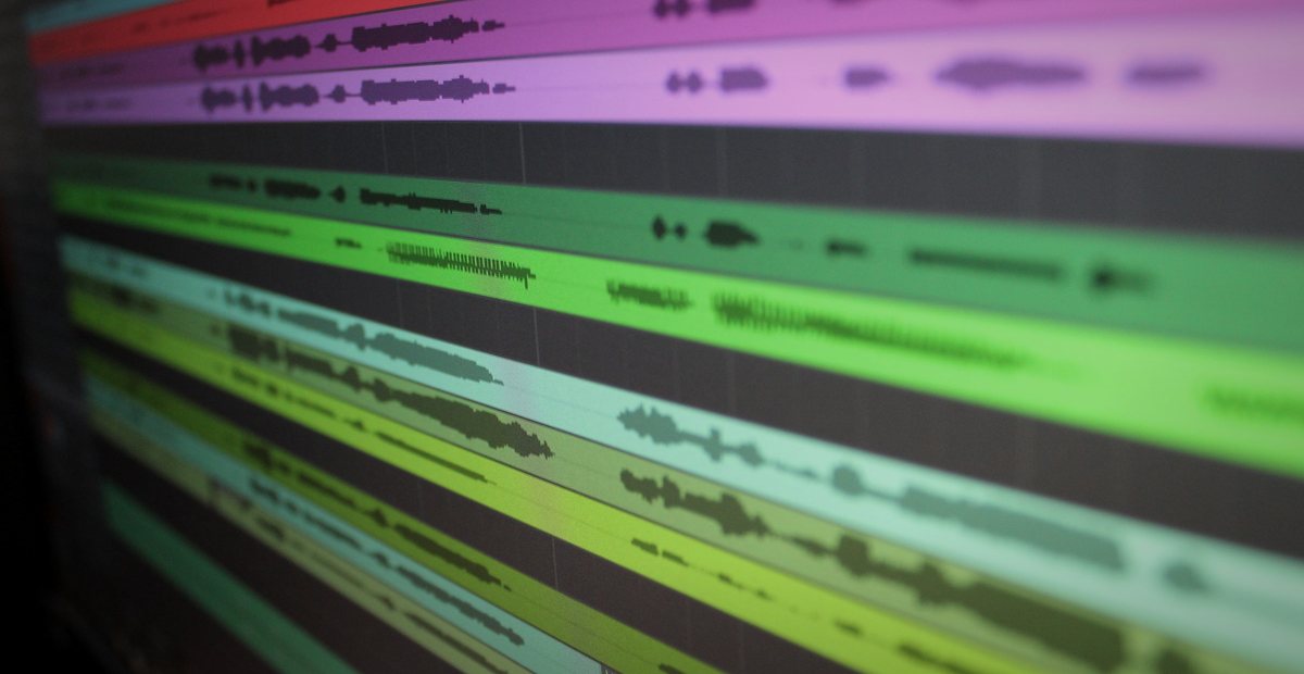 A DAW timeline showing layered audio track waveforms